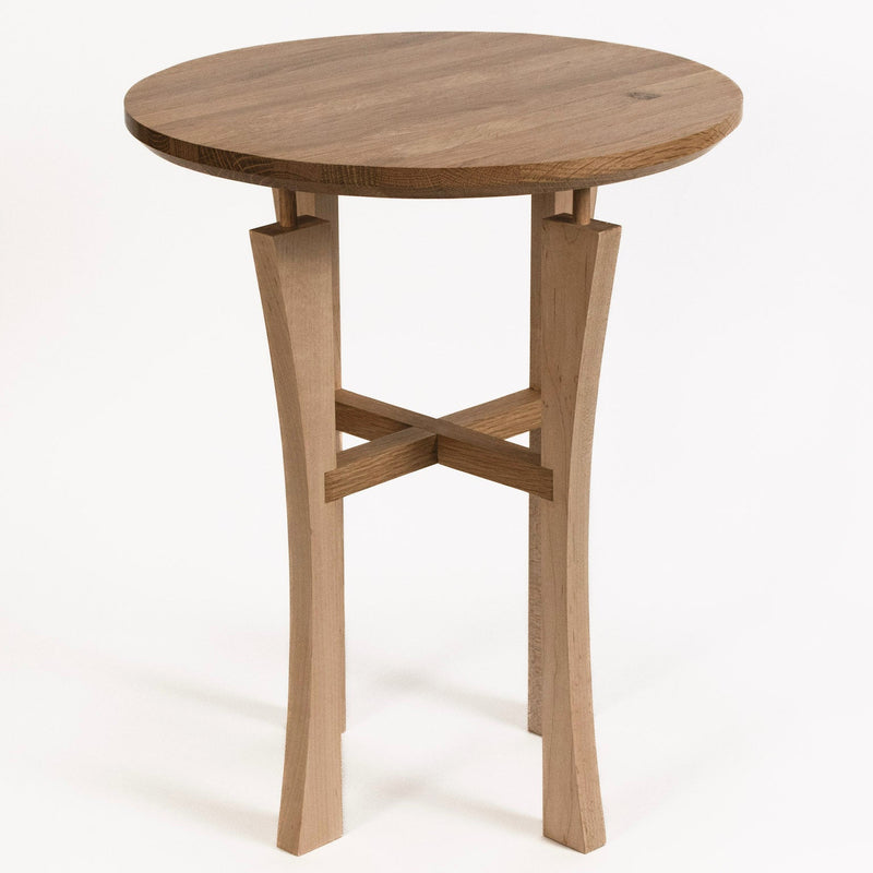 Round wooden table with a simple design on a white background