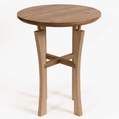 Round wooden table with a simple design on a white background